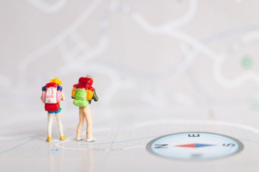 Miniature people : Traveler with backpack walking on map , Travel and Adventure concepts.