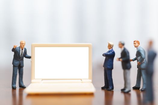 Miniature people: Businessman thinking with project for presenting investment on White screen computer laptop , Business and technology  concept