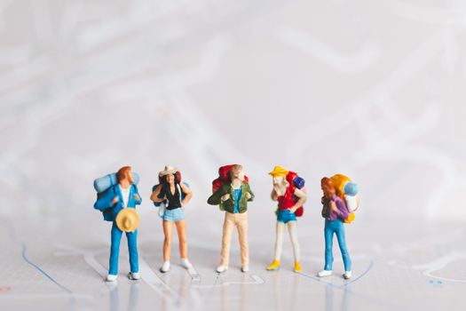 Miniature people : Traveler with backpack walking on map , Travel and Adventure concepts.