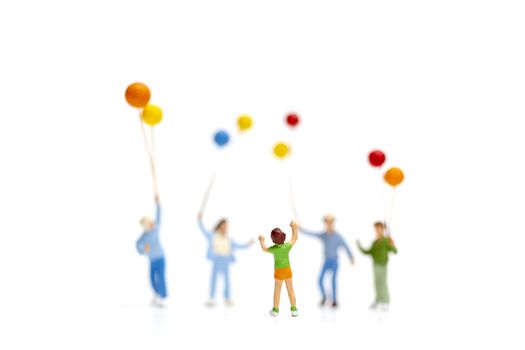 Miniature people children holding balloon isolate on white background, happy family day concept.