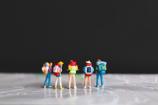 Miniature people : Traveler with backpack walking on map , Travel and Adventure concepts.
