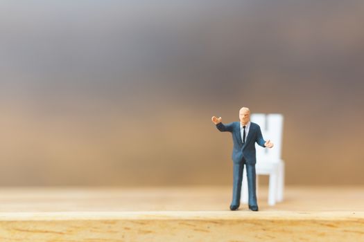 Miniature people Thinking about next great idea on wooden background and copy space for text