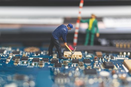 Miniature people : Worker team of engineers repairing keyboard computer laptop. Computer repair concept.
