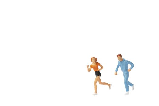 Miniature people : Couple running on white background , Healthy lifestyle and sport concepts.
