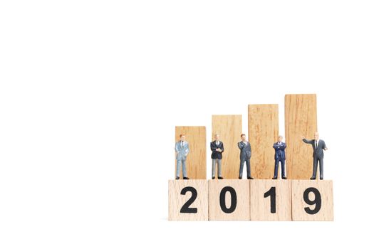 Miniature people : businessman  standing and thinking on wooden block number 2019. on white background