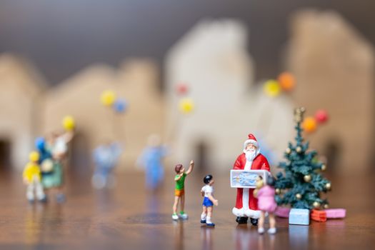 Miniature people: Santa Claus and happy family   , Merry Christmas and Happy New Year concept.