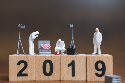 Miniature people :Crime Scene Investigation on wooden block Number 2019