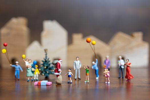 Miniature people: Santa Claus and happy family   , Merry Christmas and Happy New Year concept.