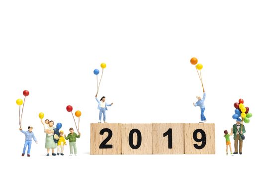 Miniature people : Happy family holding balloon on Number 2019 and copy space for text