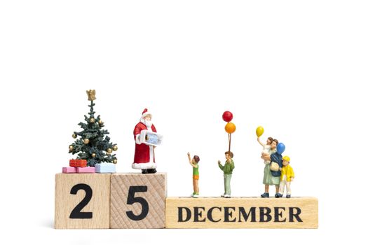 Miniature people : Santa Claus holding gift for happy family , Christmas and Happy New Year concept.