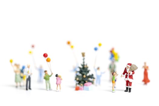 Miniature people : Santa Claus holding gift for happy family , Christmas and Happy New Year concept.