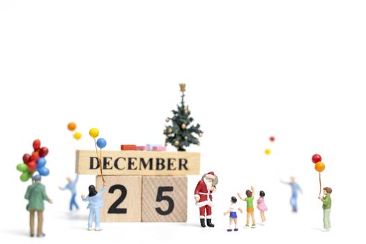 Miniature people : Santa Claus holding gift for happy family , Christmas and Happy New Year concept.