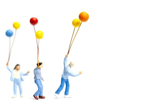 Miniature people : Children holding balloon on white background