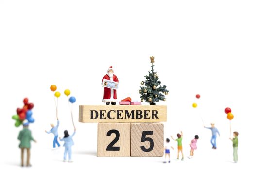 Miniature people : Santa Claus holding gift for happy family , Christmas and Happy New Year concept.
