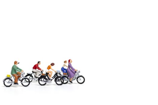 Miniature people : Friend Group ride bicycle  isolate on white background , Travel concept