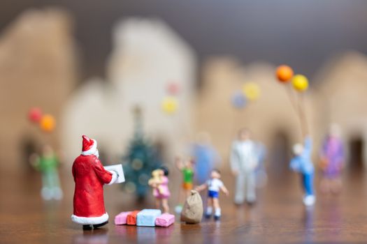 Miniature people: Santa Claus and happy family   , Merry Christmas and Happy New Year concept.