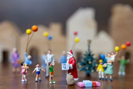 Miniature people: Santa Claus and happy family   , Merry Christmas and Happy New Year concept.