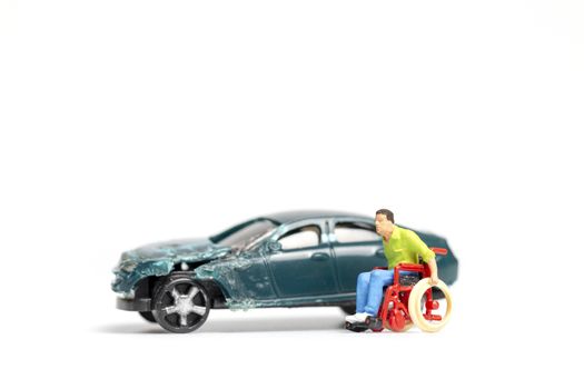 Miniature people : Man on wheelchair and car wreck , Don't drink and drive concept.