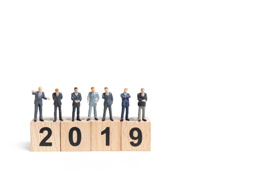 Miniature people : businessman  standing and thinking on wooden block number 2019. on white background