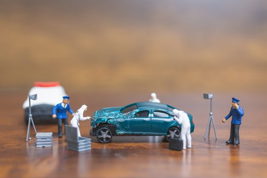 Miniature people : Police And Detective standing in front of car , Crime Scene Investigation concept