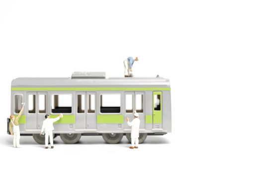 Miniature people : Painters painting a Train on white background , Repairing concept