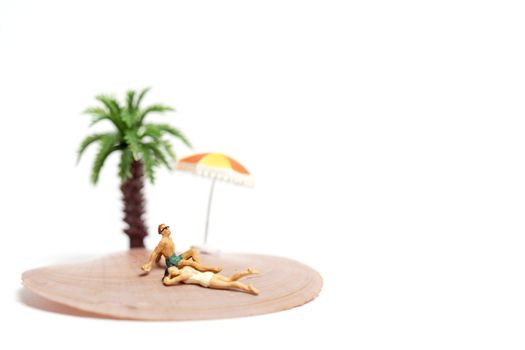 Miniature people  wearing swimsuit relaxing on  seashells  on white background , Valentine's Day concept