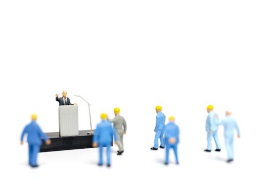 Miniature people : a politician speaking to the people during an election rally 