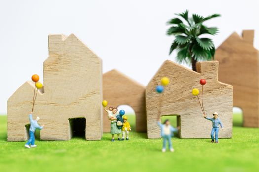 Miniature people : Happy family walking in field with balloons ,   Happy family relations and carefree leisure time Concept
