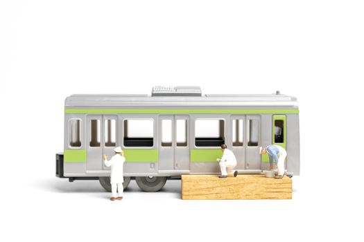 Miniature people : Painters painting a Train on white background , Repairing concept