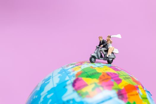 Miniature people : Couple riding the motorcycle on The Globe , Valentines concept