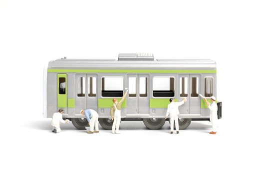 Miniature people : Painters painting a Train on white background , Repairing concept