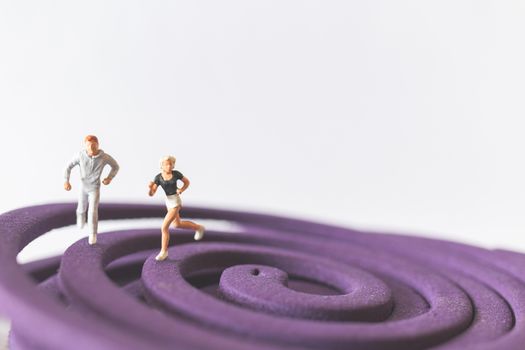 Miniature people : Couple Runnig on the purple field , Valentine's Day concept