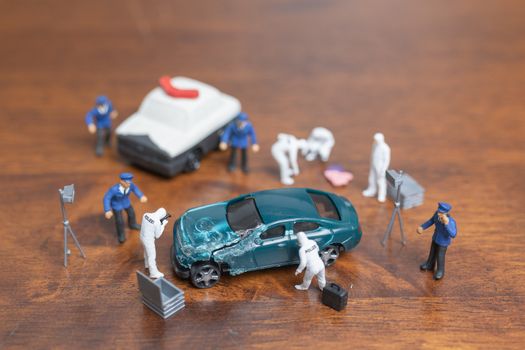 Miniature people : Police And Detective standing in front of car , Crime Scene Investigation concept