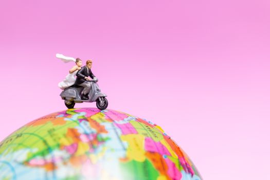 Miniature people : Couple riding the motorcycle on The Globe , Valentines concept