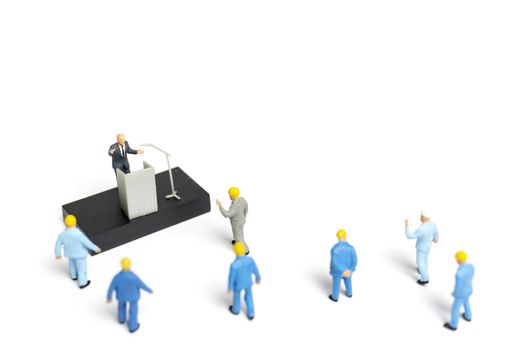 Miniature people : A politician speaking to the people during an election rally 