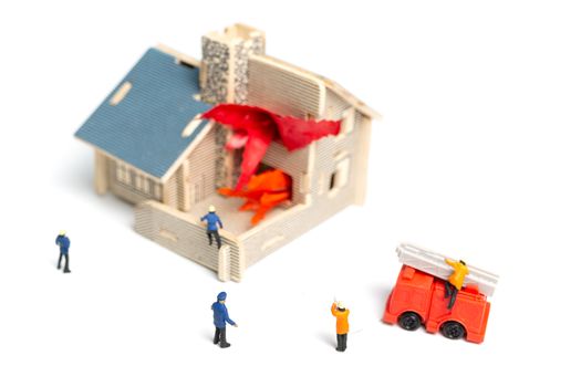 Miniature people : Firefighters with water pistols are taking care of a fire emergency