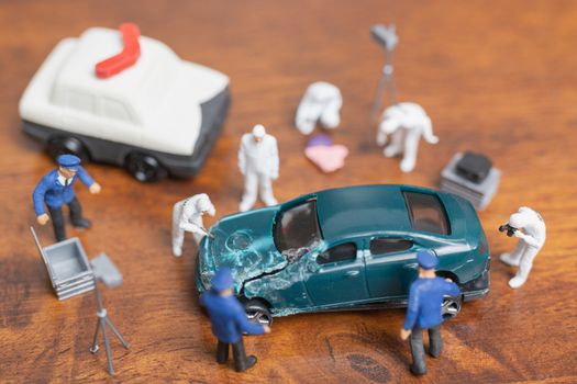 Miniature people : Police And Detective standing in front of car , Crime Scene Investigation concept