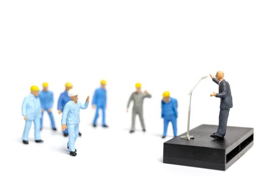 Miniature people : A politician speaking to the people during an election rally 