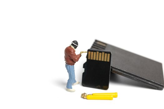 Miniature people technician fixing pile of sd cards on white background with copy space.