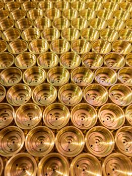 an abstract perspective industrial close-up background of shiny brass metal threaded hexagonal fitting parts.