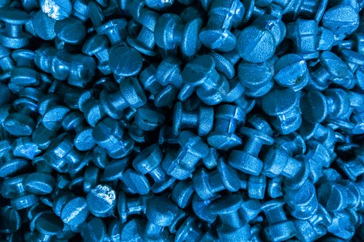 An abstract industrial full frame background of forged and sanded steel billets. Classic blue color toned backdrop.. Close-up with selective focus and optical blur.
