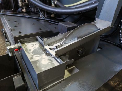 disk type oil skimmer for liquid flood coolant in modern cnc milling machine - close-up with selective focus