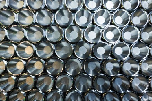 a batch of shiny metal cnc aerospace parts production - close-up with selective focus for industrial background in flat lay composition