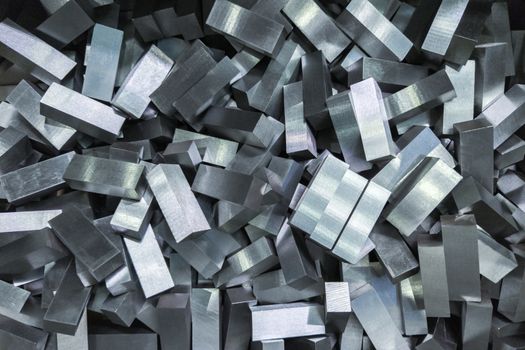 a pile of shiny faceted steel blocks - full frame close-up with selective focus, view directly from above