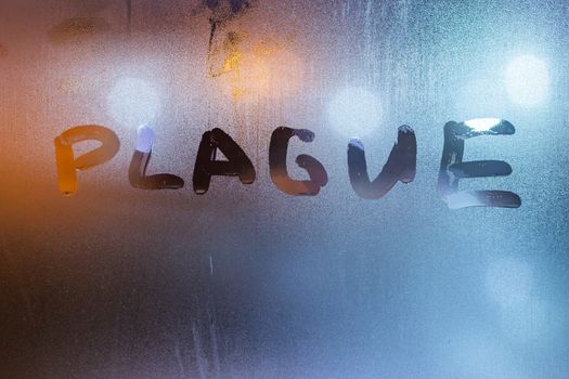 The word plague handwritten on sweat window glass surface at night. Pandemic concept.