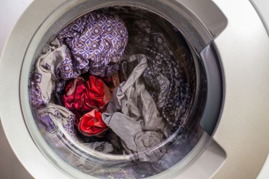 a close view of domestic washing machine at work.