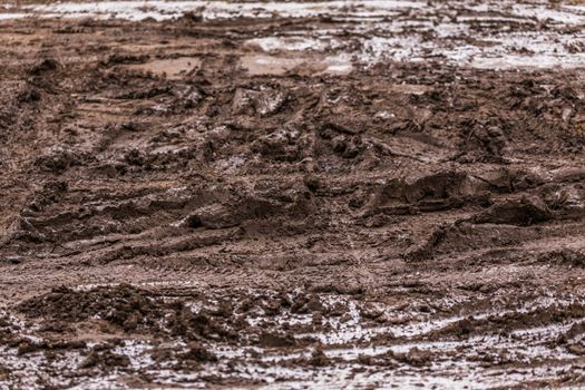 dirty mud road background at winter with selective focus and blur ft loudy weather