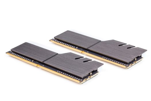 a pair of ddr4 dimm pc ram memoty modules with stylish black heatsinks - isolated on white with selective focus.