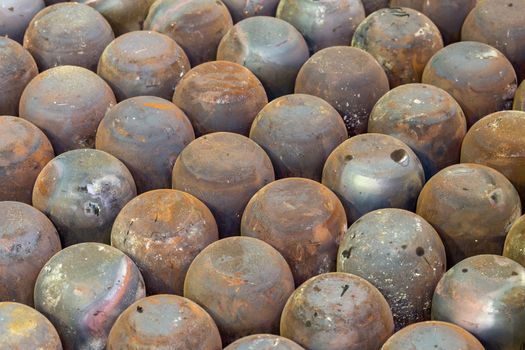 abstract full frame industrial background of rusted steel dome round workpieces after thick sheet steel draw process