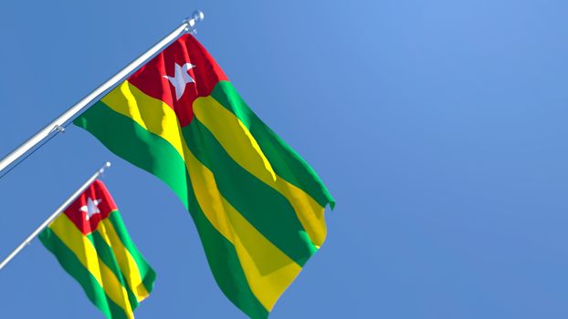 3D rendering of the national flag of Togo waving in the wind against a blue sky